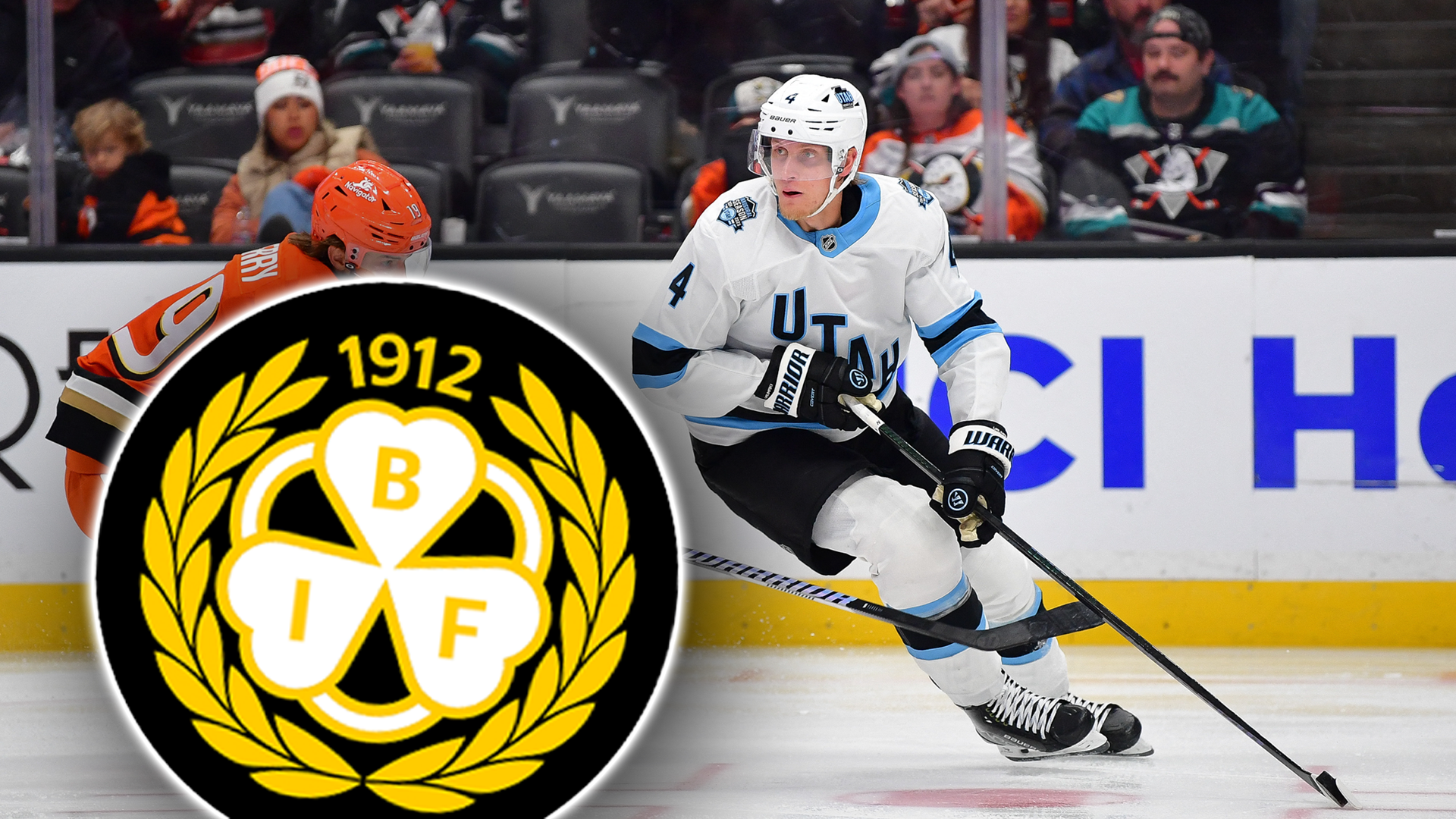 En ishockeyspelare i vit och blå tröja spelar under en match. Klubbloggan för BIF (Brynäs IF) från 1912 är placerad i förgrunden av bilden.