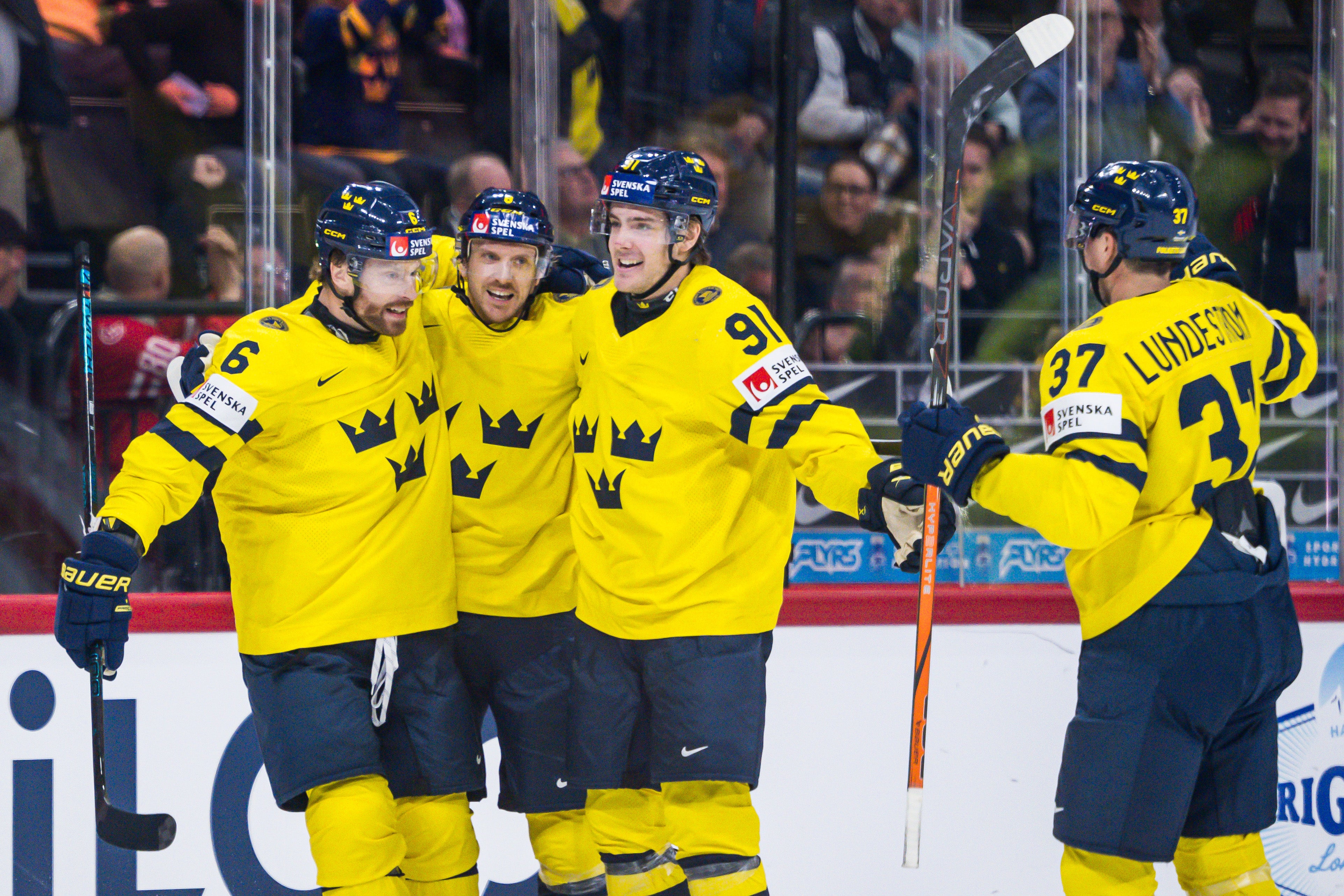Adam Larsson, Leo Carlsson and Isac Lundeström celebrate with Jonas Brodin