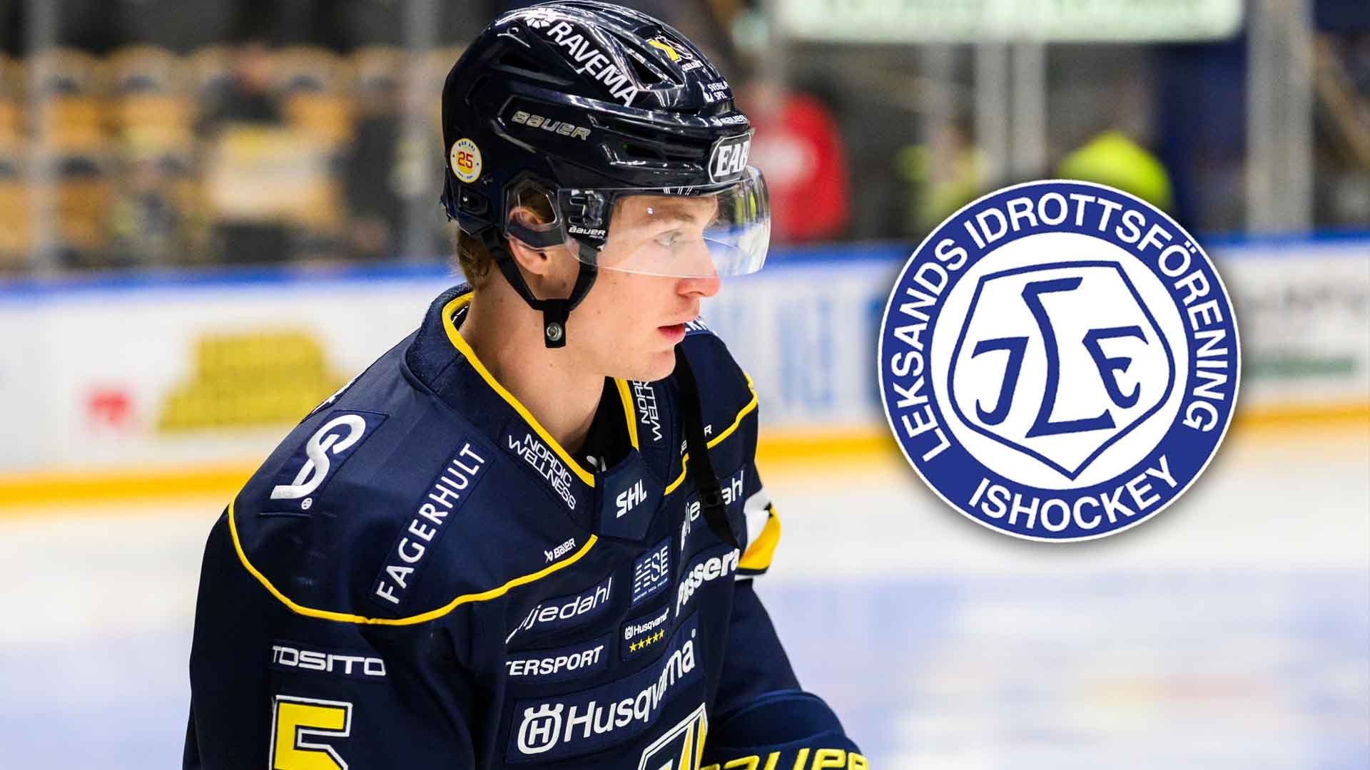Ishockeyspelare i mörkblå och gul tröja under en match.