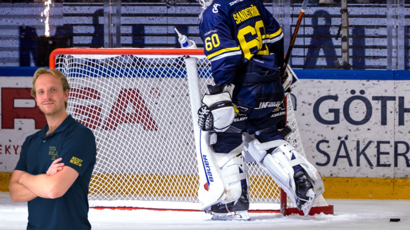 Ishockeyspelare i mörkblå tröja vid målet under en match.