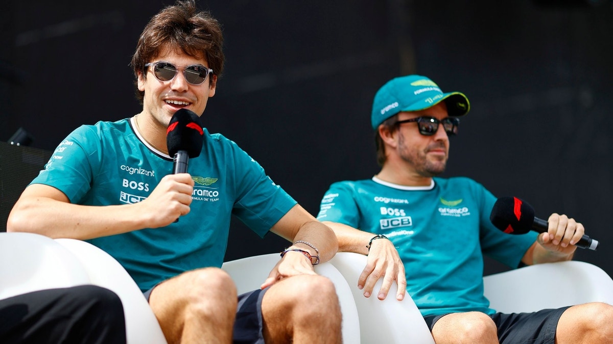 Lance Stroll och Fernando Alonso under ett F1 fan-event.