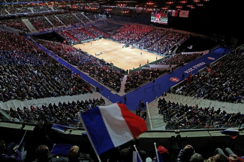 A fan waves a French flag during the first Davis Cup final singles tennis match at the Pierre-Mauroy stadium in Villeneuve d’Ascq