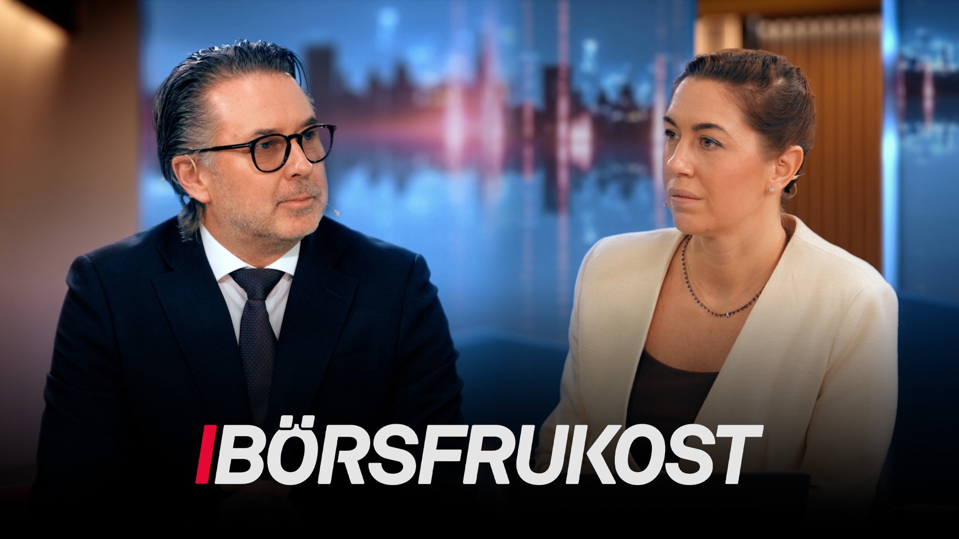 Två affärspersoner i studiomiljö med stadshorisont i bakgrunden