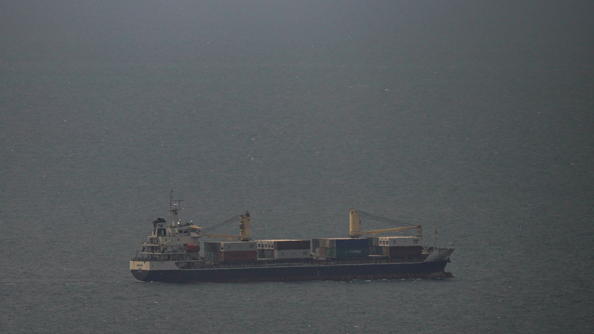 Ett lastfartyg på öppet vatten under dimmiga förhållanden.