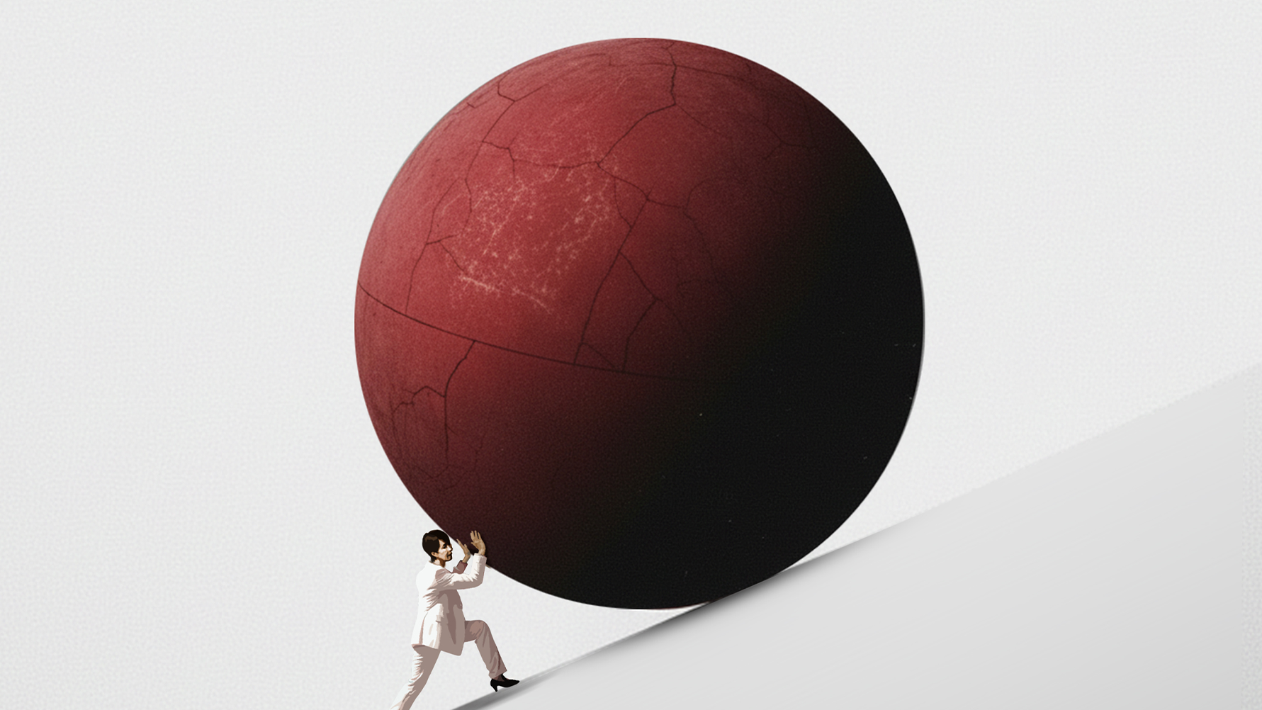 Person som skjuter en stor röd sfär uppför en lutning