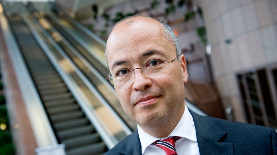 Frédéric Cho, Kina-expert. På bilden iklädd kostym, röd slips och glasögon.