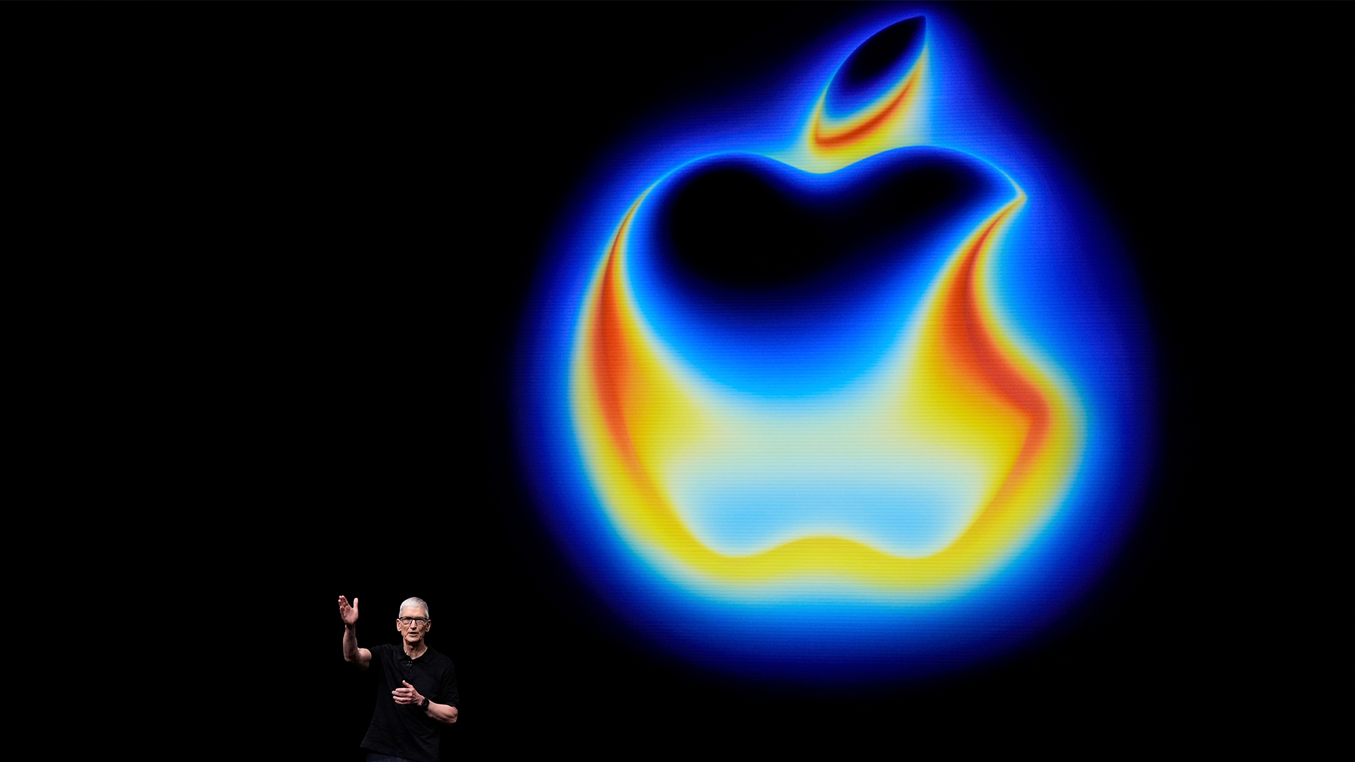 Glödande Apple-logotyp med blå, gul och orange neoneffekt mot svart bakgrund