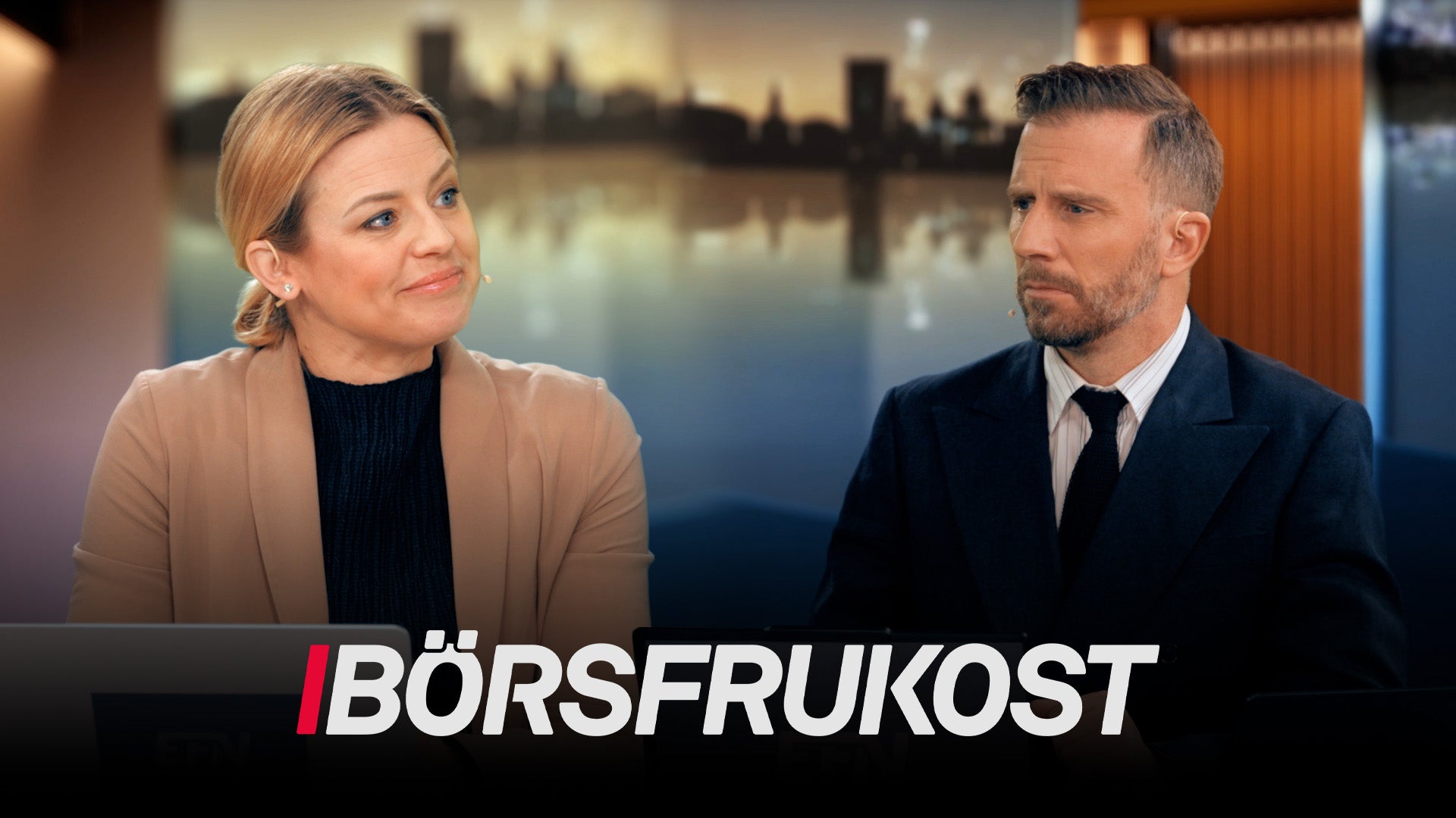 Två personer i en studiosetting med en stadsutsikt över vatten i bakgrunden. Texten "Börsfrukost" visas längst ned.