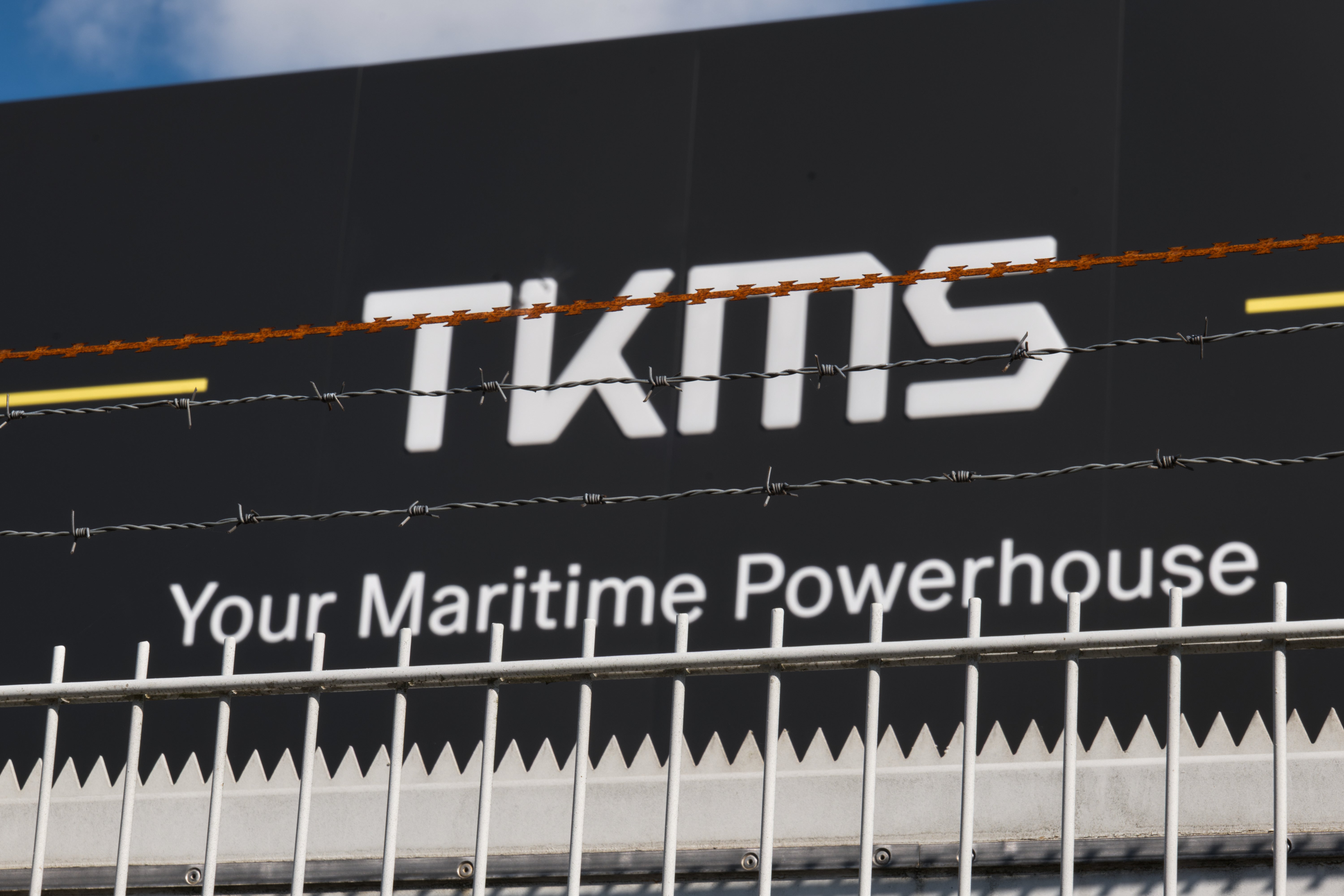 KMS-skylt med texten 'Your Maritime Powerhouse' och dekorativ grässtrand