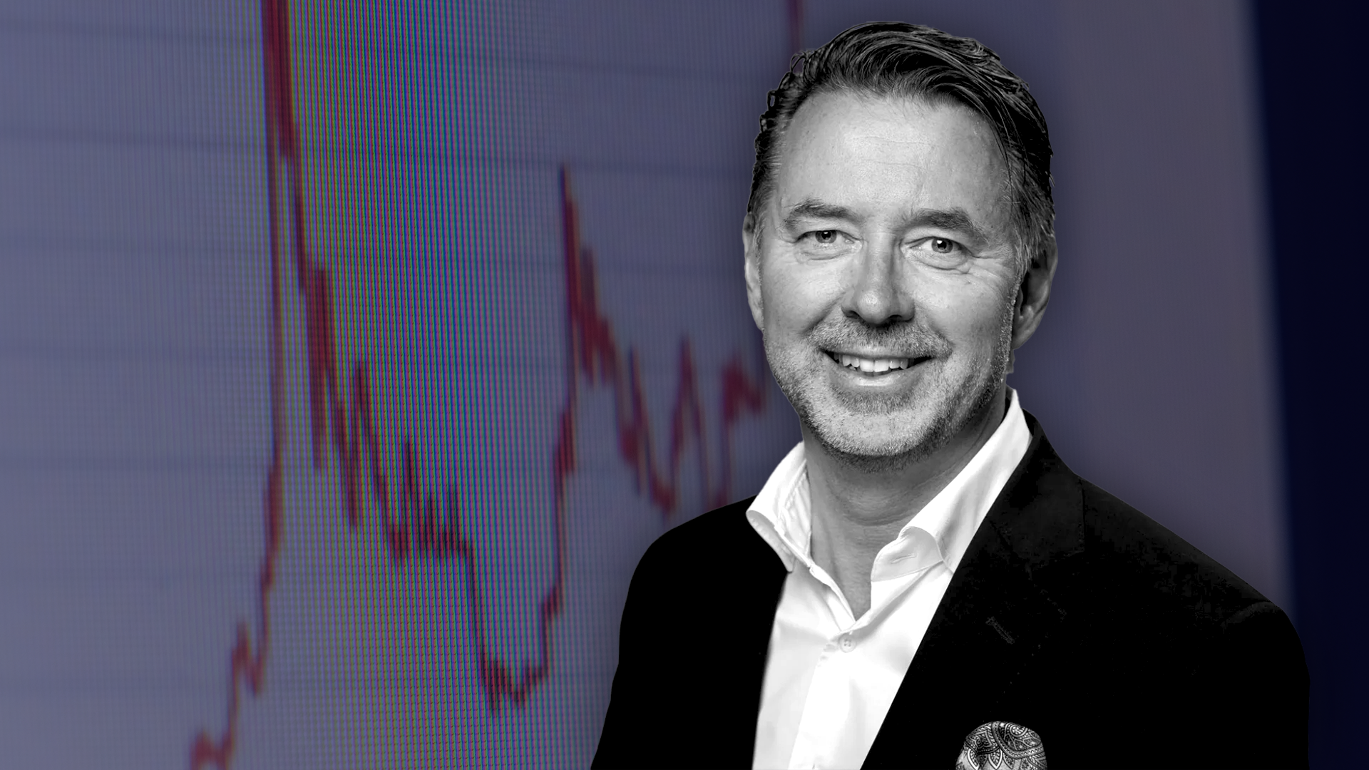 Porträtt av Fredrik Warg, man i kostym framför finansiell graf