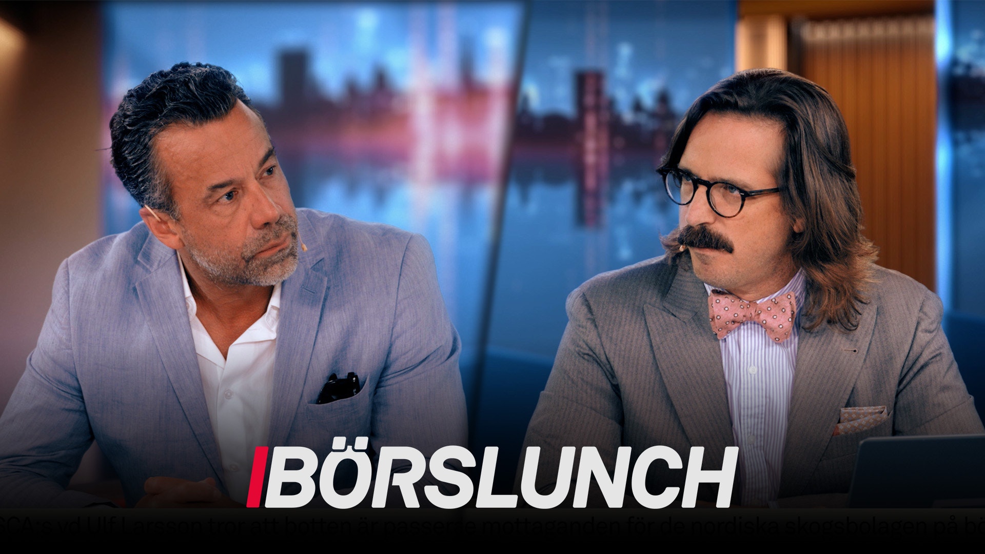 Två män i affärskläder sitter och diskuterar i en TV-studio med stadshorisont i bakgrunden. Texten Börslunch visas längst ned på skärmen.
