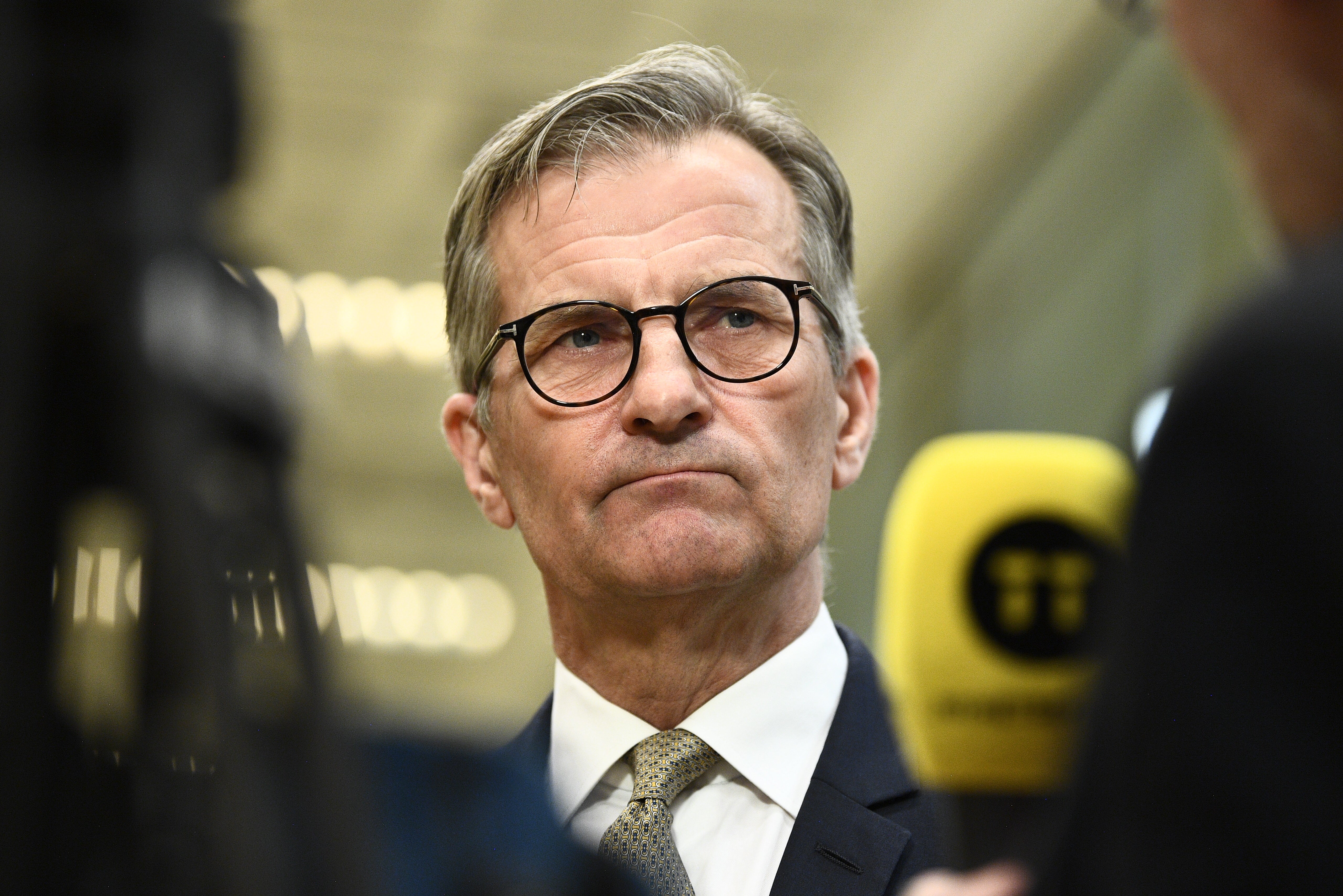 Porträtt av en man i glasögon och formell affärsklädsel