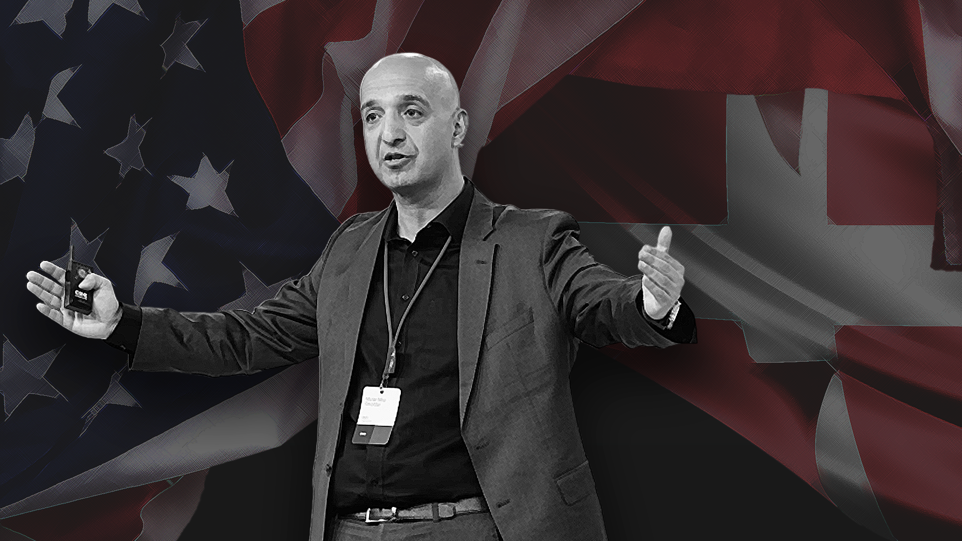 En man ger en presentation framför amerikanska och kanadensiska flaggor