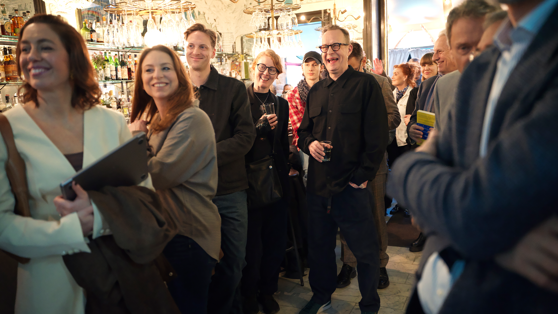 En grupp människor samlade inomhus vid ett socialt event eller möte.