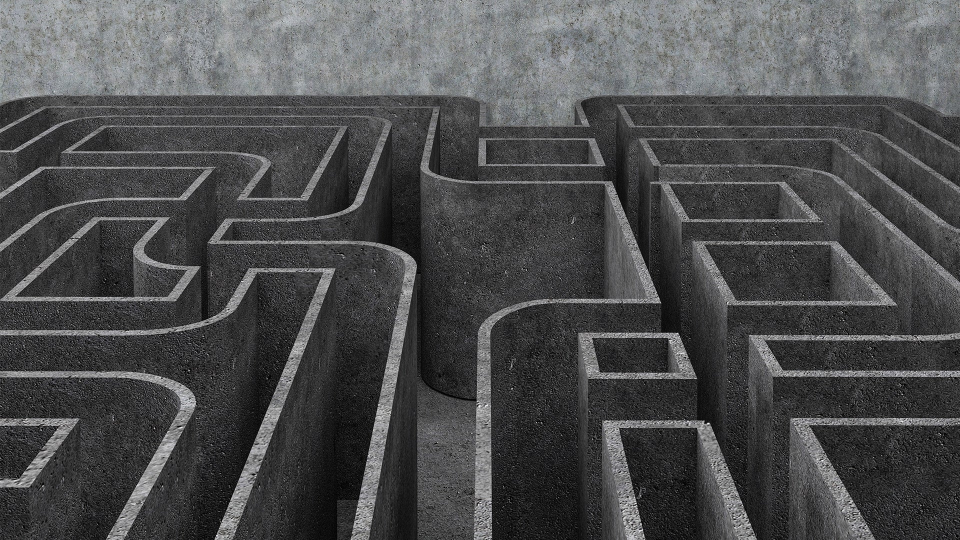 Labyrint sedd från ovan med gångar och väggar i grå betong.