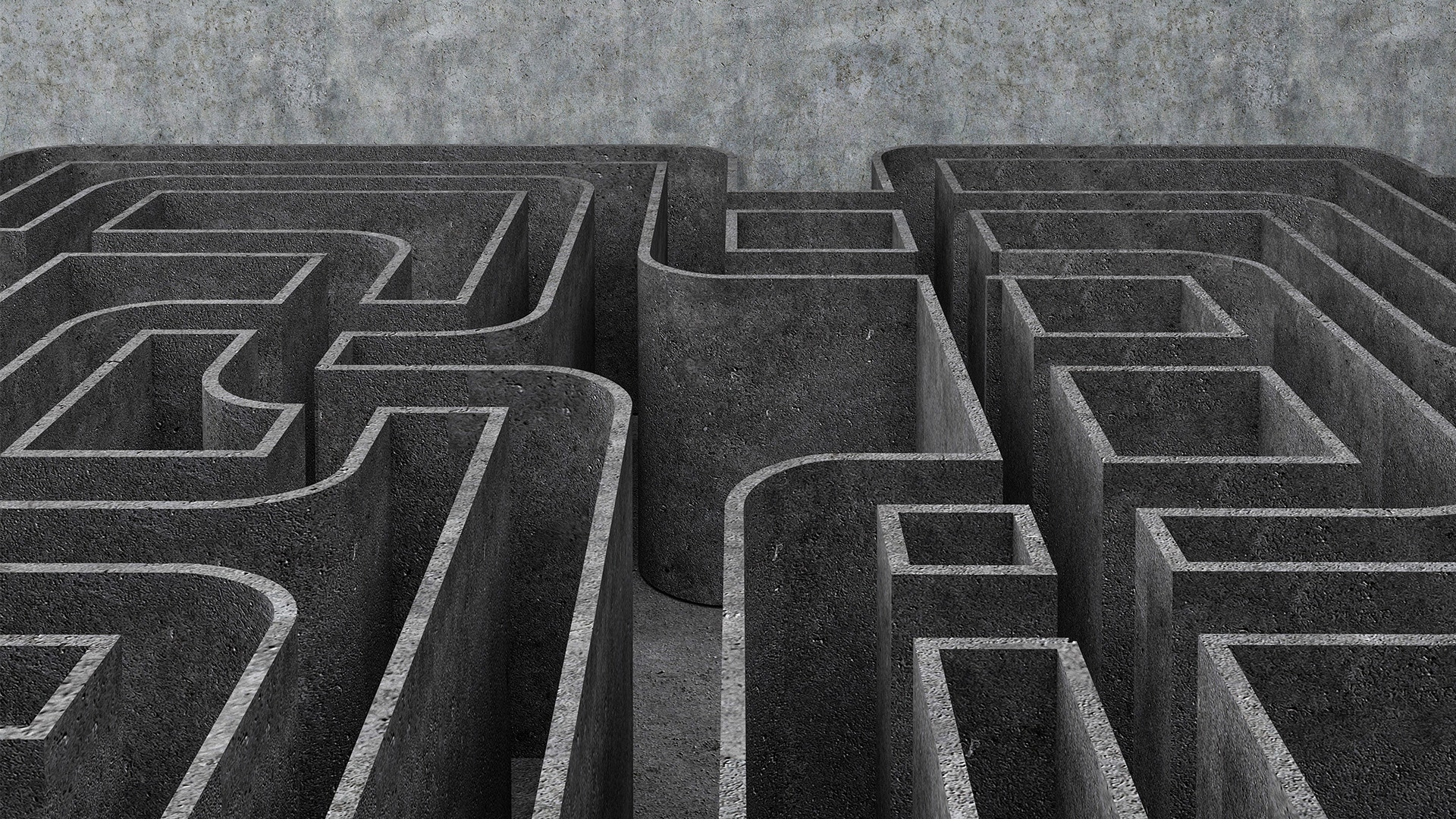 Labyrint sedd från ovan med gångar och väggar i grå betong.