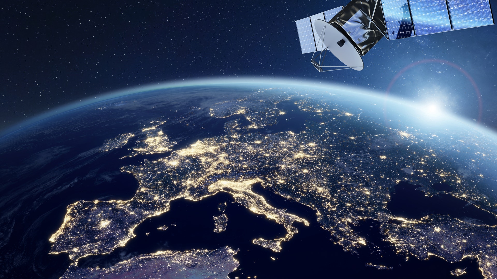 Kommunikationssatellit i omloppsbana runt jorden med nattbelyst kontinentalkarta synlig nedan