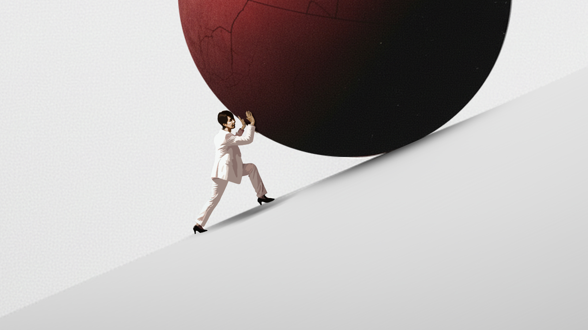 Person i affärskläder skjuter en stor mörk sfär uppför en sluttning