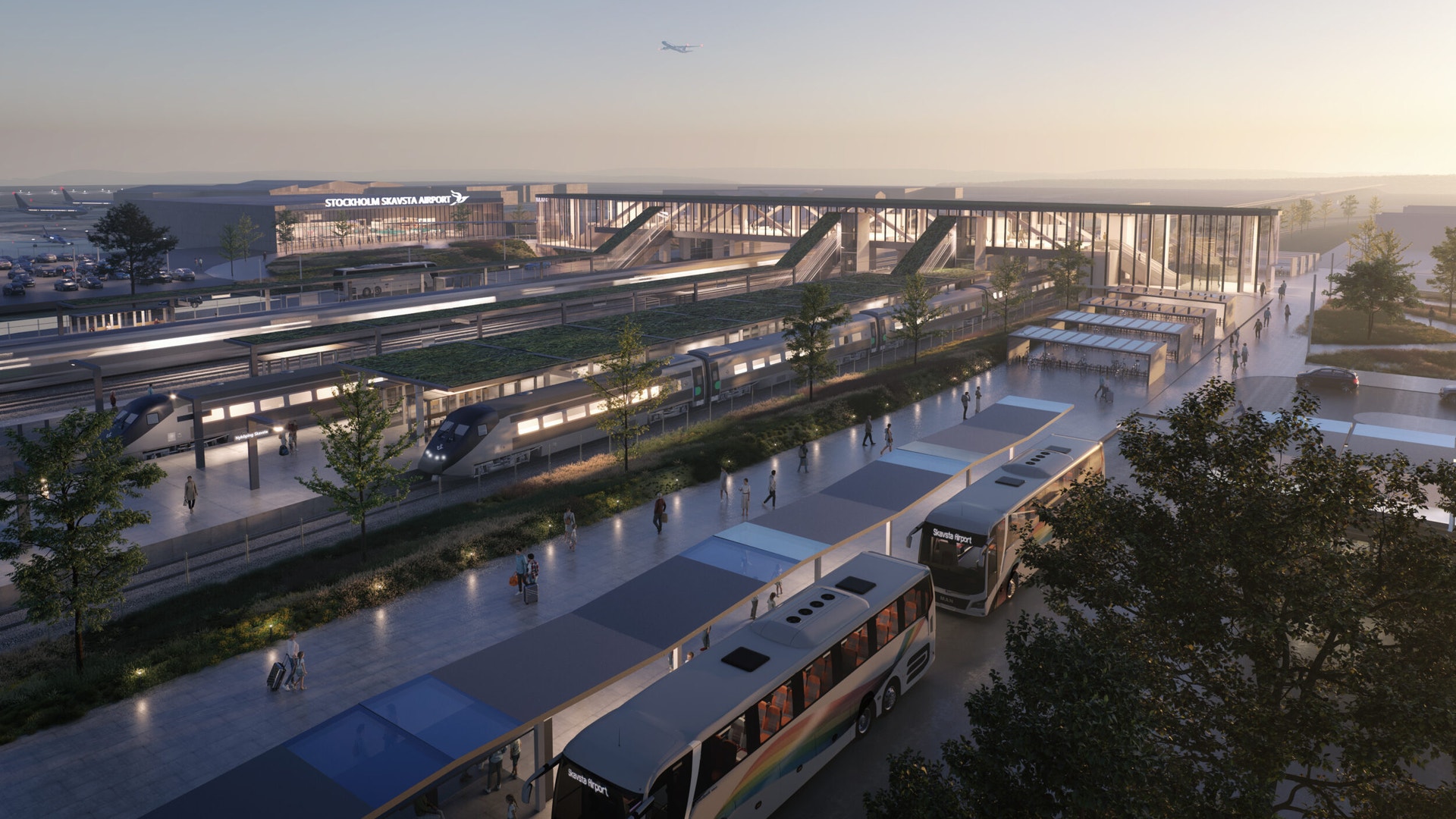 Arkitektskiss av en flygplatsterminal i skymning, med tåg och bussar som ansluter till byggnaden.
