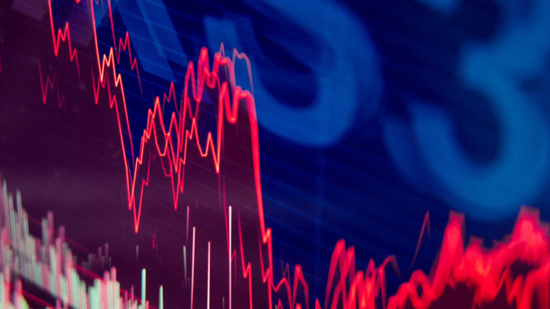 Finansiell graf med röda nedåtgående trendlinjer på blå bakgrund, symboliserar aktiemarknadens nedgång.
